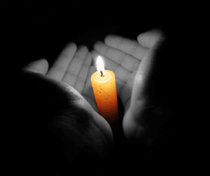 hands around a candle